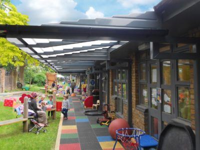 Children Playing Outside Under School Canopy