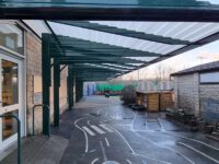 large playground shelter covering the play area of a school