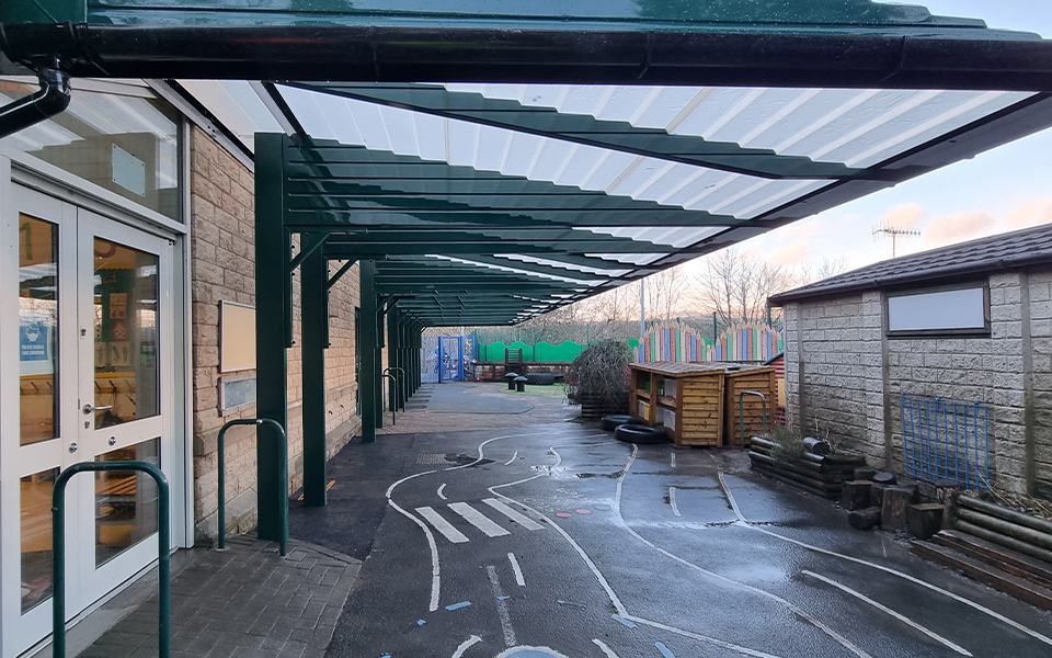 large playground shelter covering the play area of a school