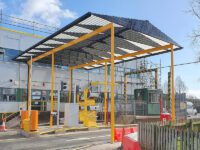 A very large industrial loading bay shelter in yellow and grey colours