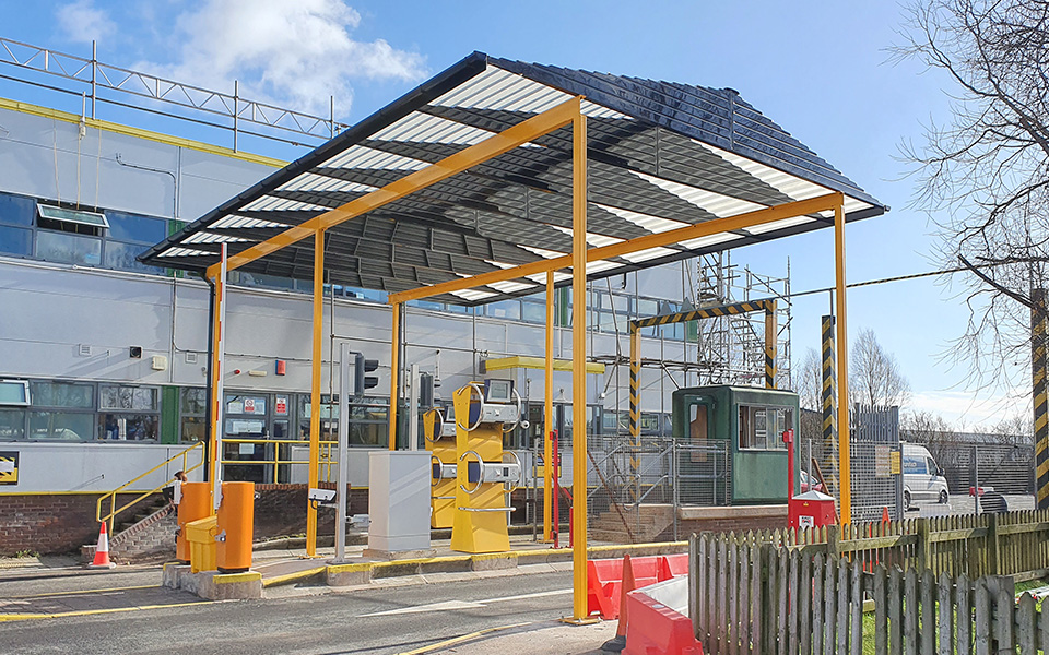 A very large industrial loading bay shelter in yellow and grey colours