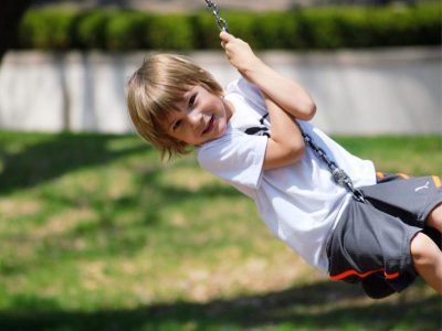 child playing on swing