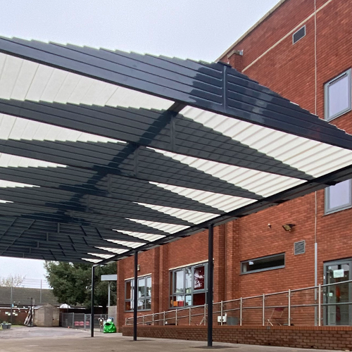 Showing the underneath of a large blue playground canopy installed at Abington Vale Primary School